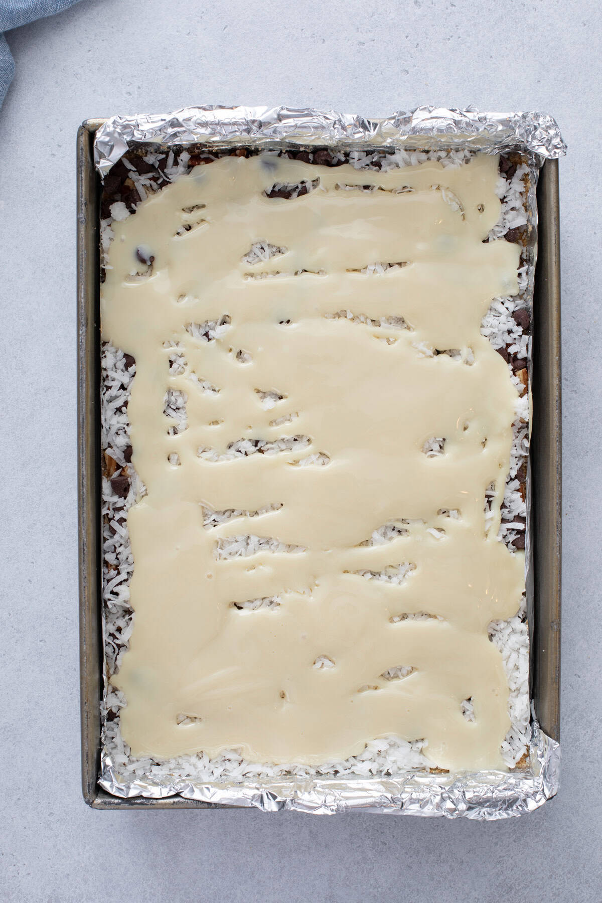 Assembled magic bars ready to go in the oven.