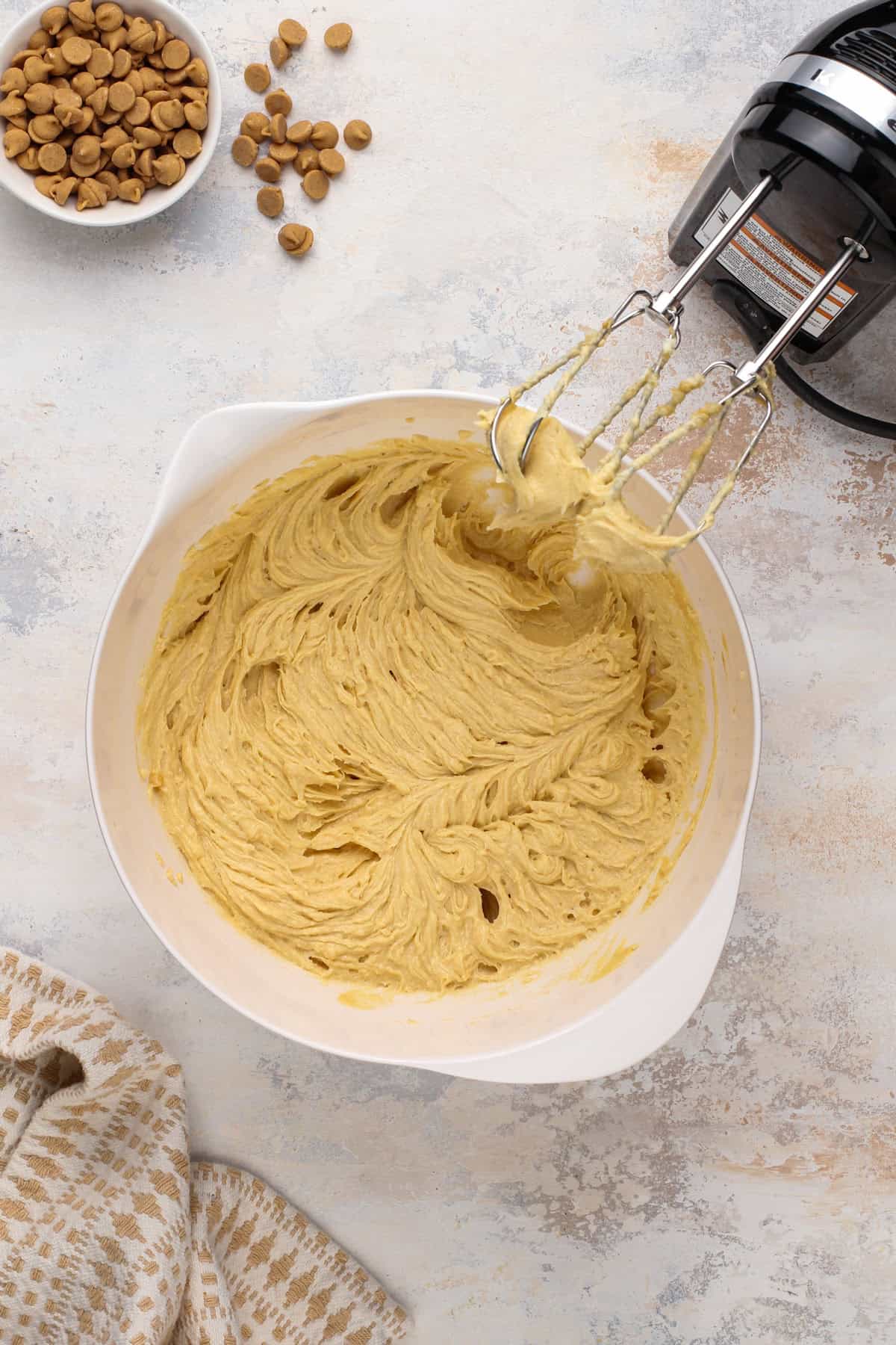 Wet ingredients for chocolate peanut butter cookies mixed in a white bowl.