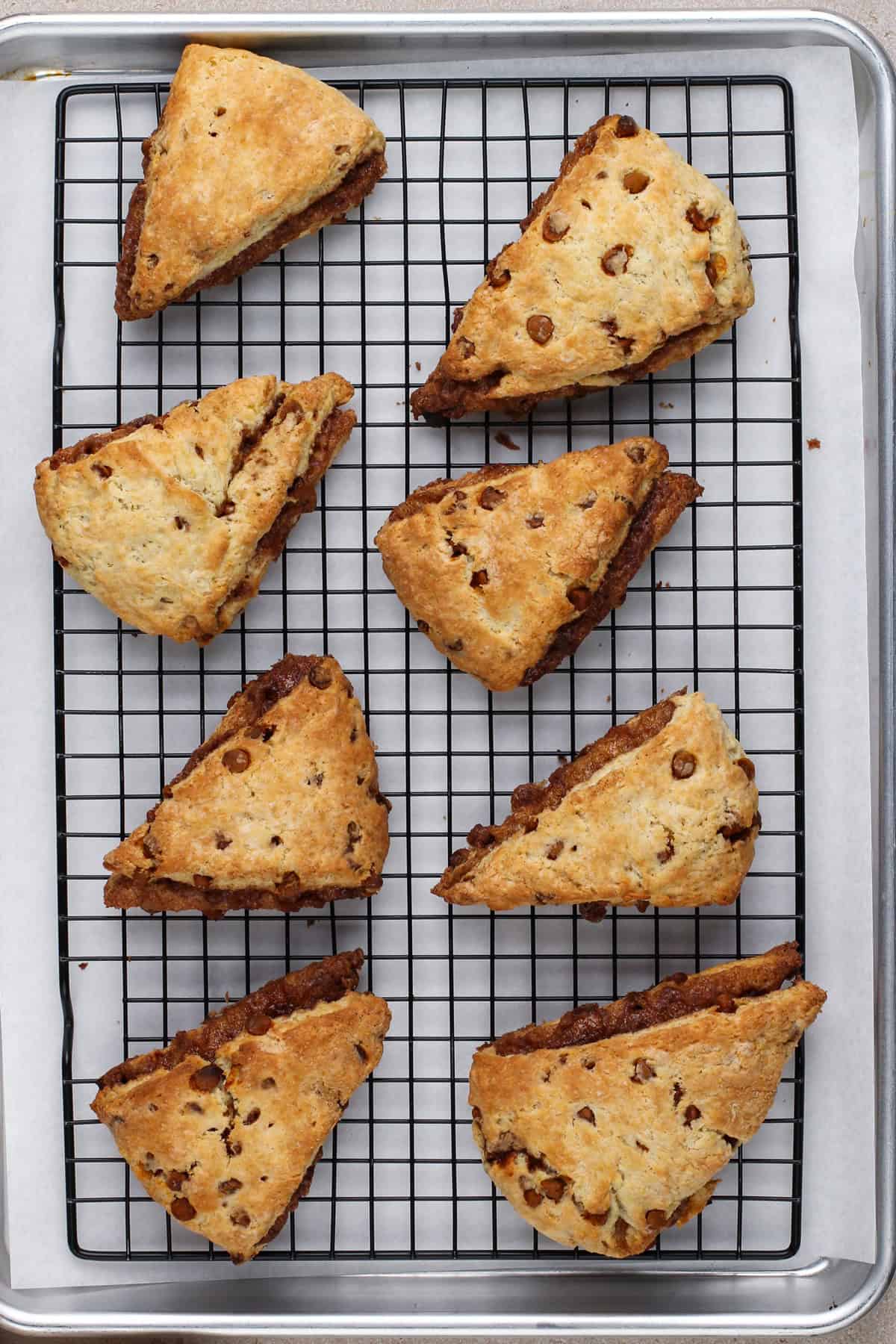 Baked cinnamon scones cooling on a wire rack.