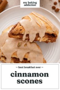 One cinnamon scone leaning against a second on a white plate. Text overlay includes recipe name.