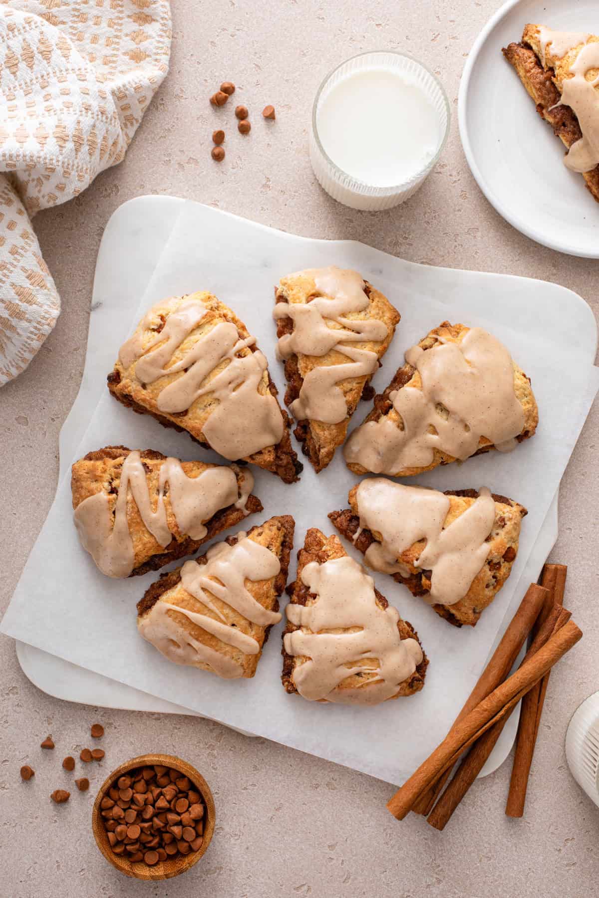 Overhead view of glazed cinnamon scones arranged in a circle.