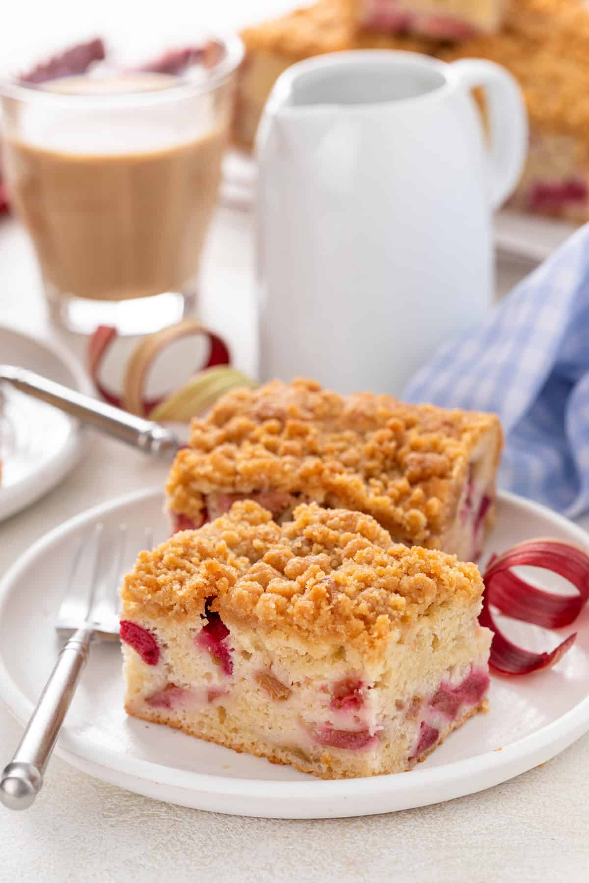 Two slices of rhubarb cake on a white plate.