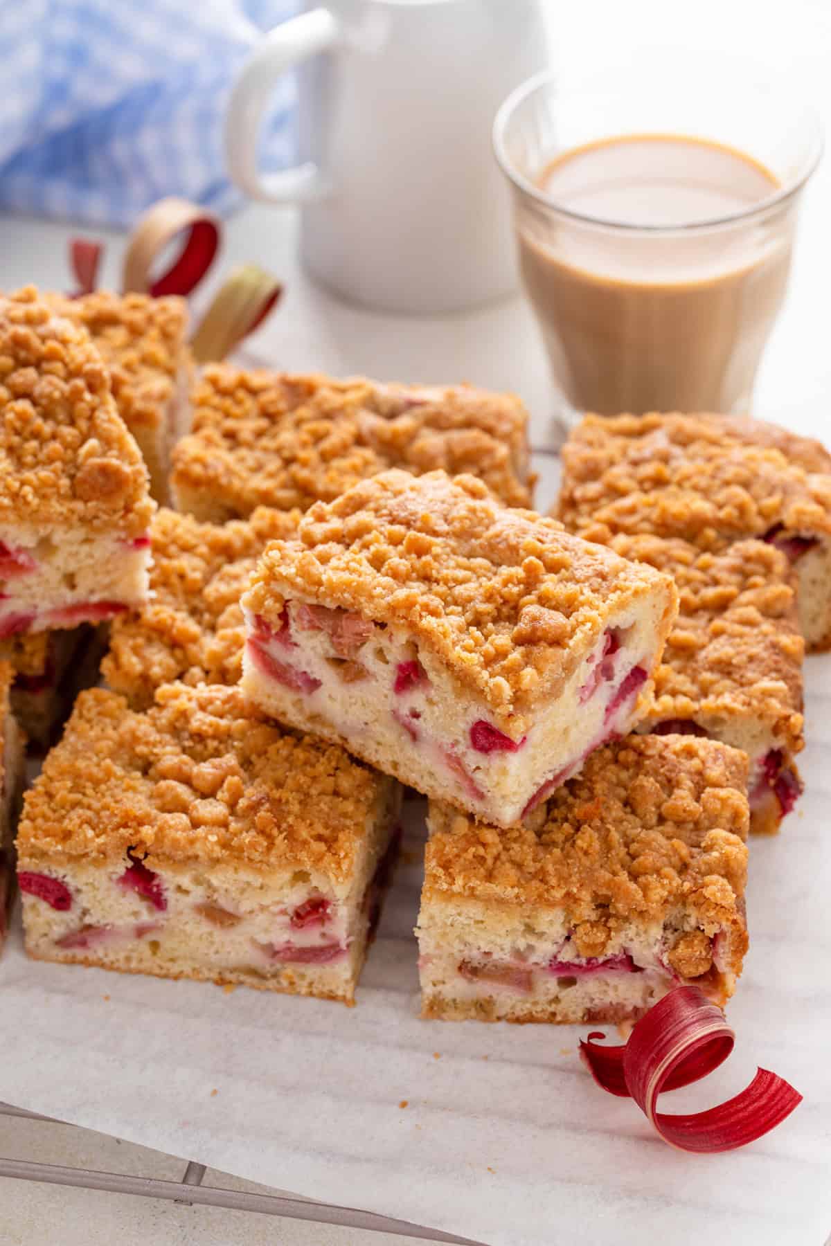 Slices of rhubarb cake arranged on a piece of parchment paper.