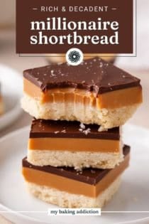 Three pieces of millionaire shortbread stacked on a plate with a bite taken from the corner. Text overlay includes recipe name.