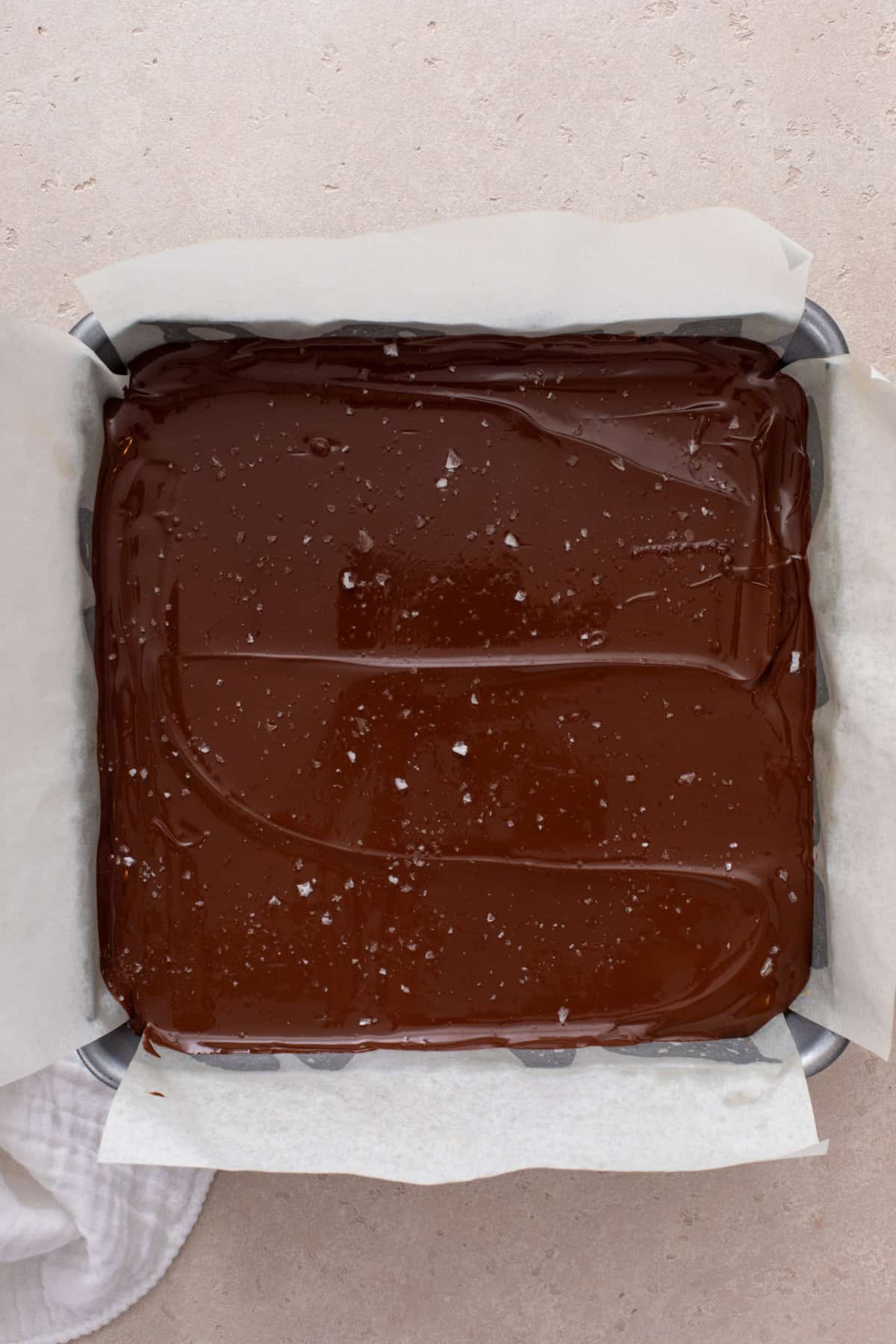 Assembled millionaire shortbread in a baking pan.