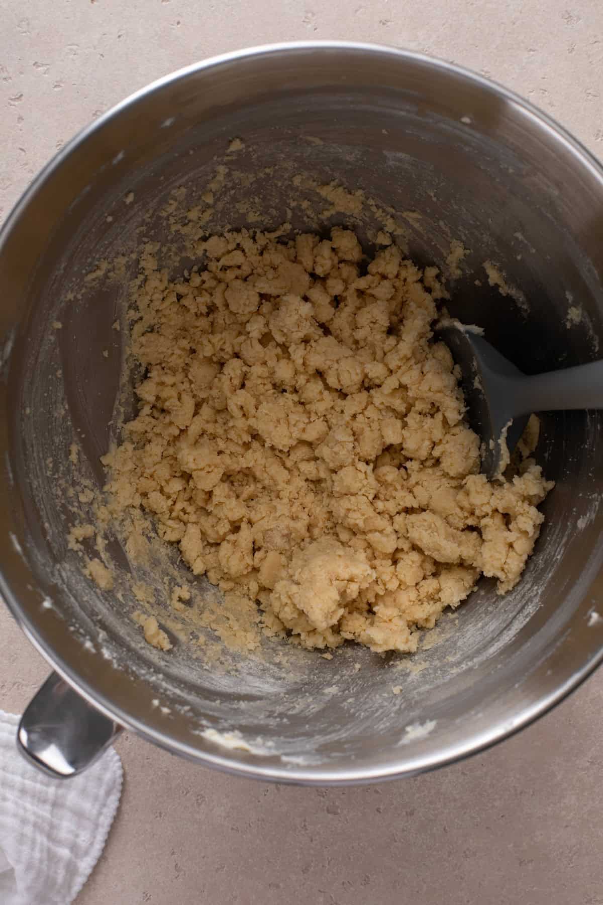 Dough for shortbread in a metal bowl.