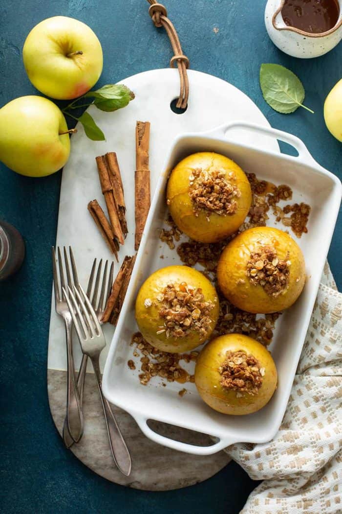 Overhead view of baked apples in a white baking dish