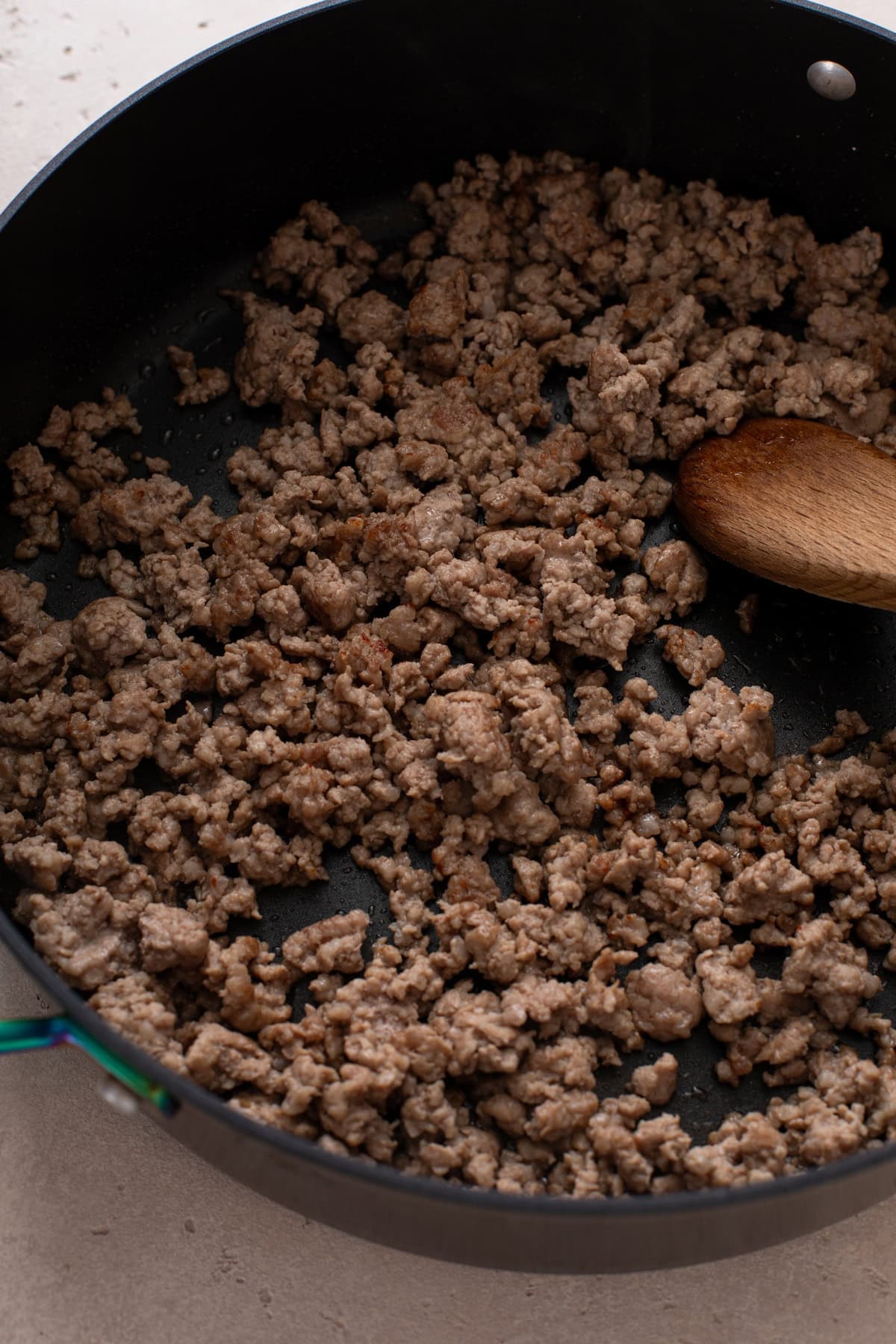 Browned italian sausage in a pan.