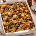 Sausage and cranberry stuffing in a white baking dish.