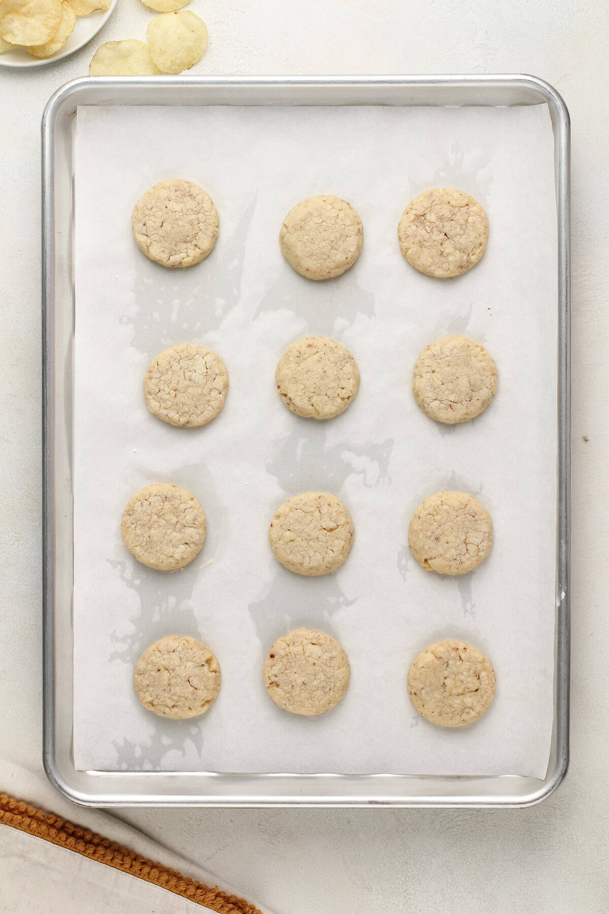 Baked potato chip cookies cooling on a baking sheet.