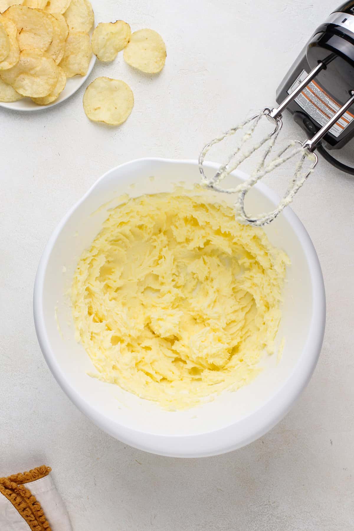 Butter and sugar creamed together in a white bowl.