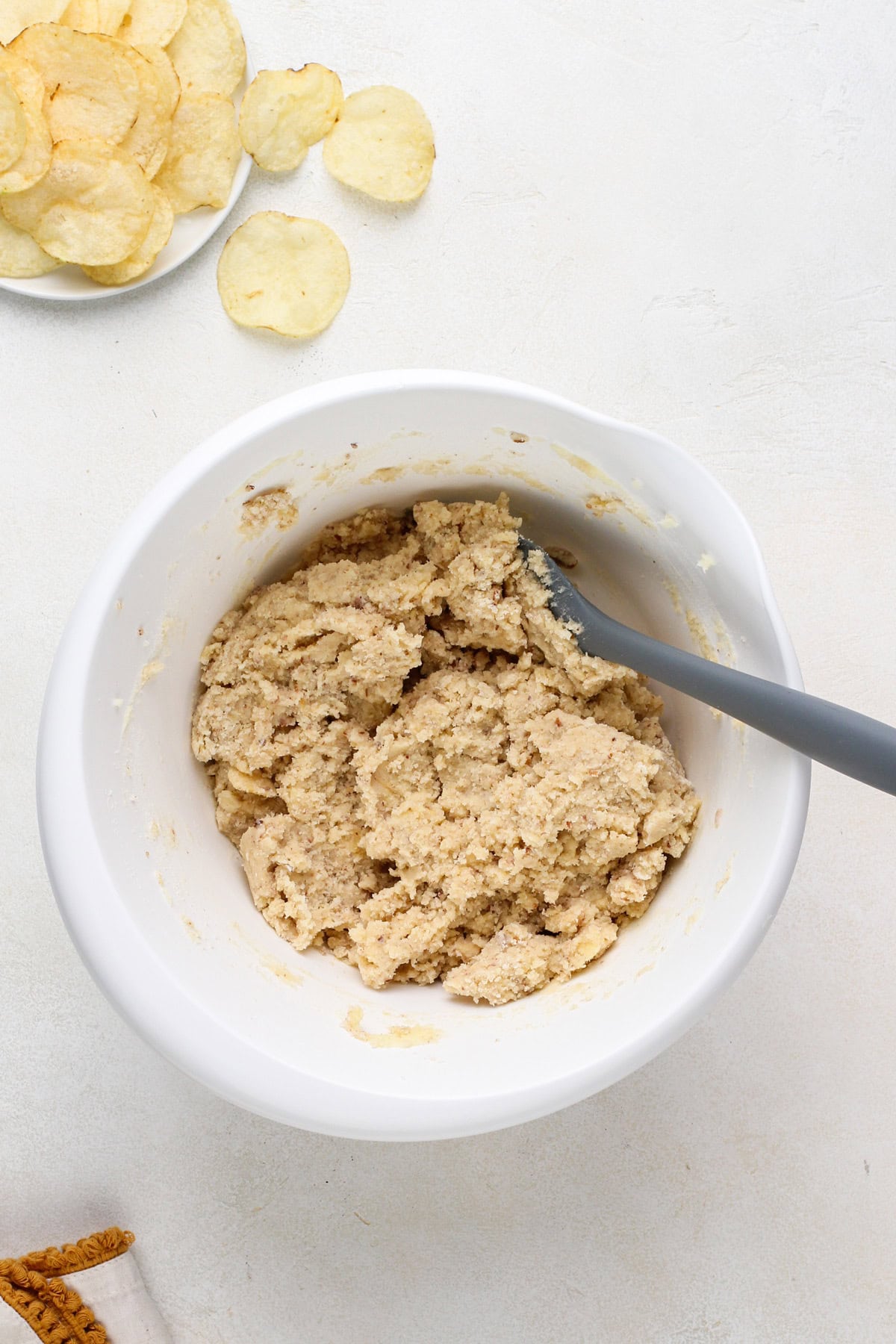 Potato chip cookie dough mixed in a white bowl.