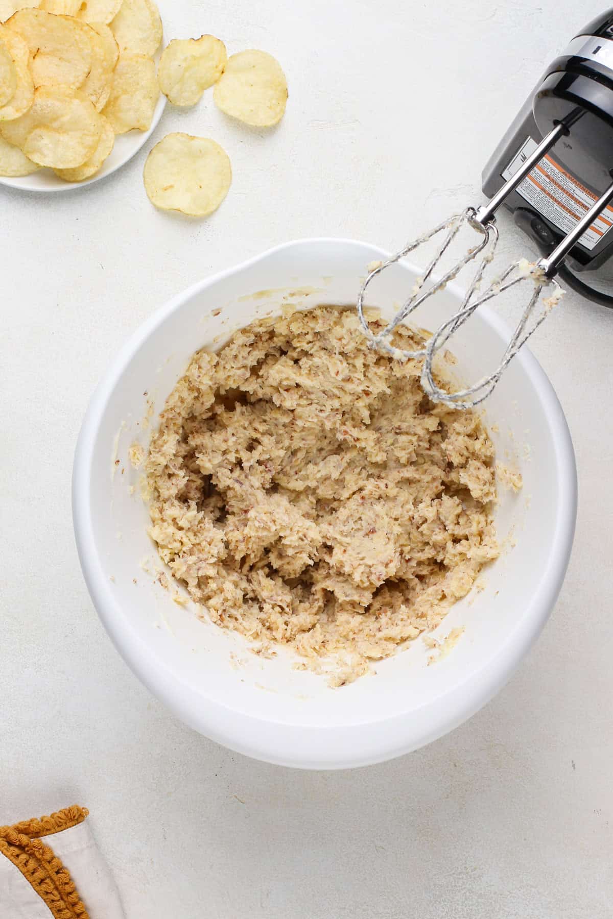 Cookie dough base for potato chip cookies mixed in a white bowl.