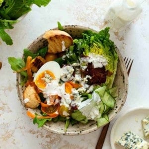 Homemade blue cheese dressing on a mixed greens salad