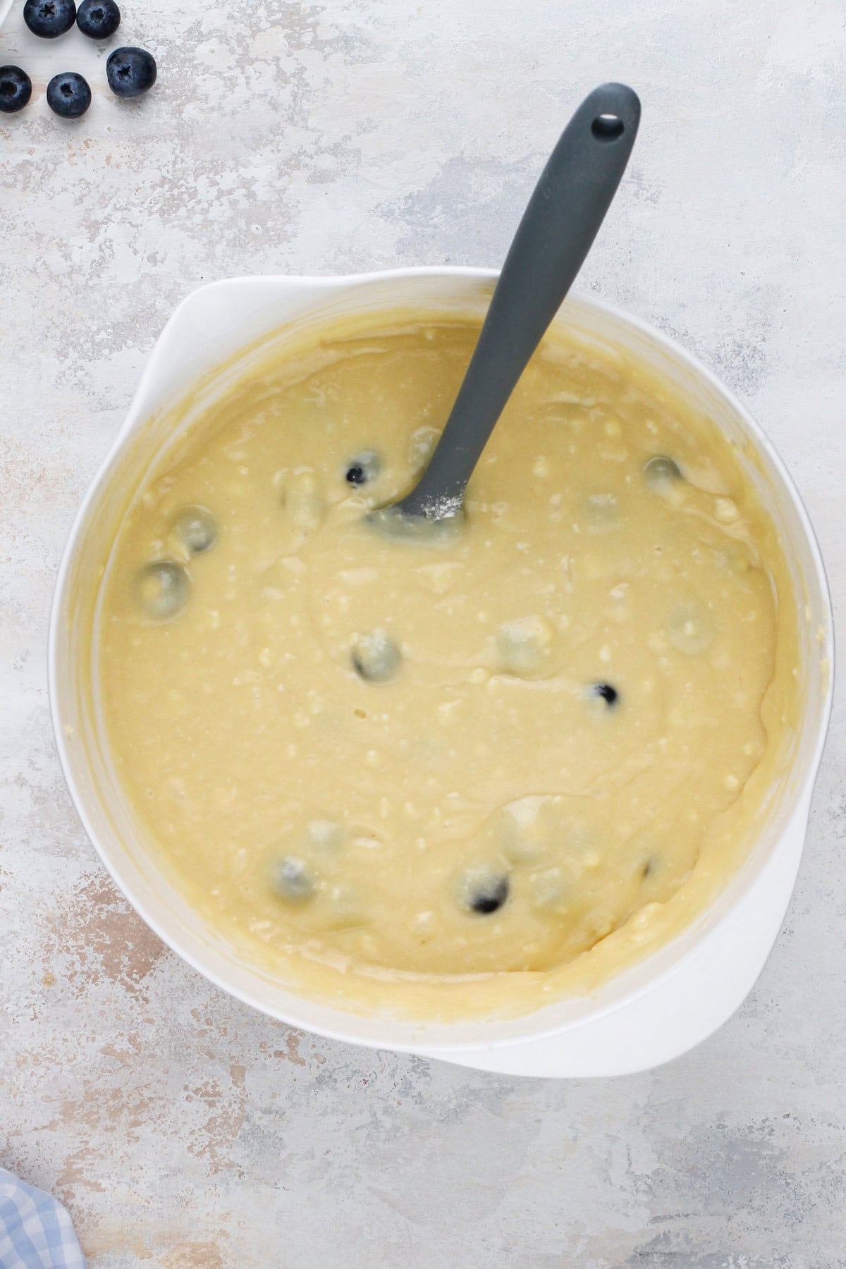 Blueberry cupcake batter mixed in a white bowl.