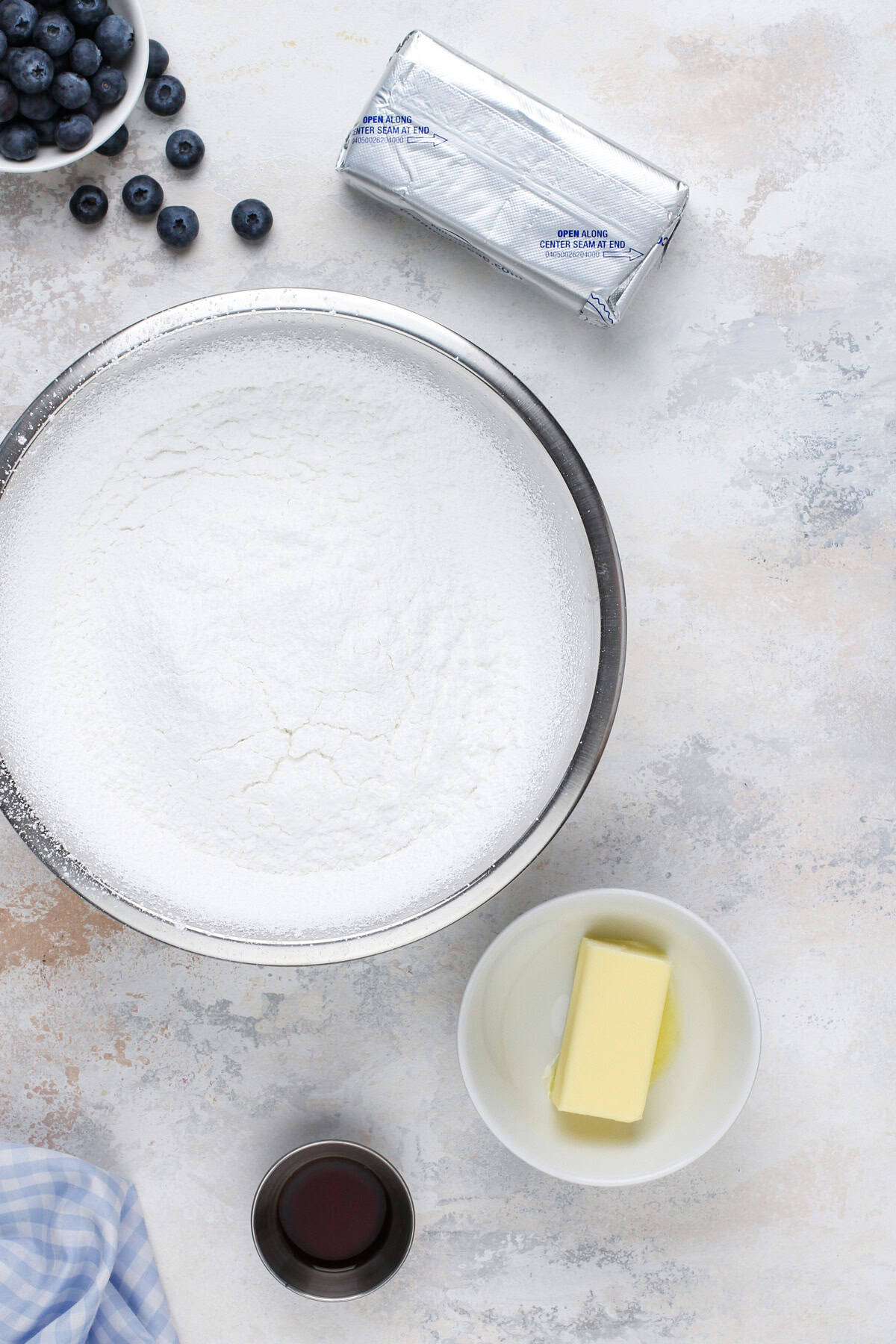 Cream cheese frosting ingredients arranged on a countertop.