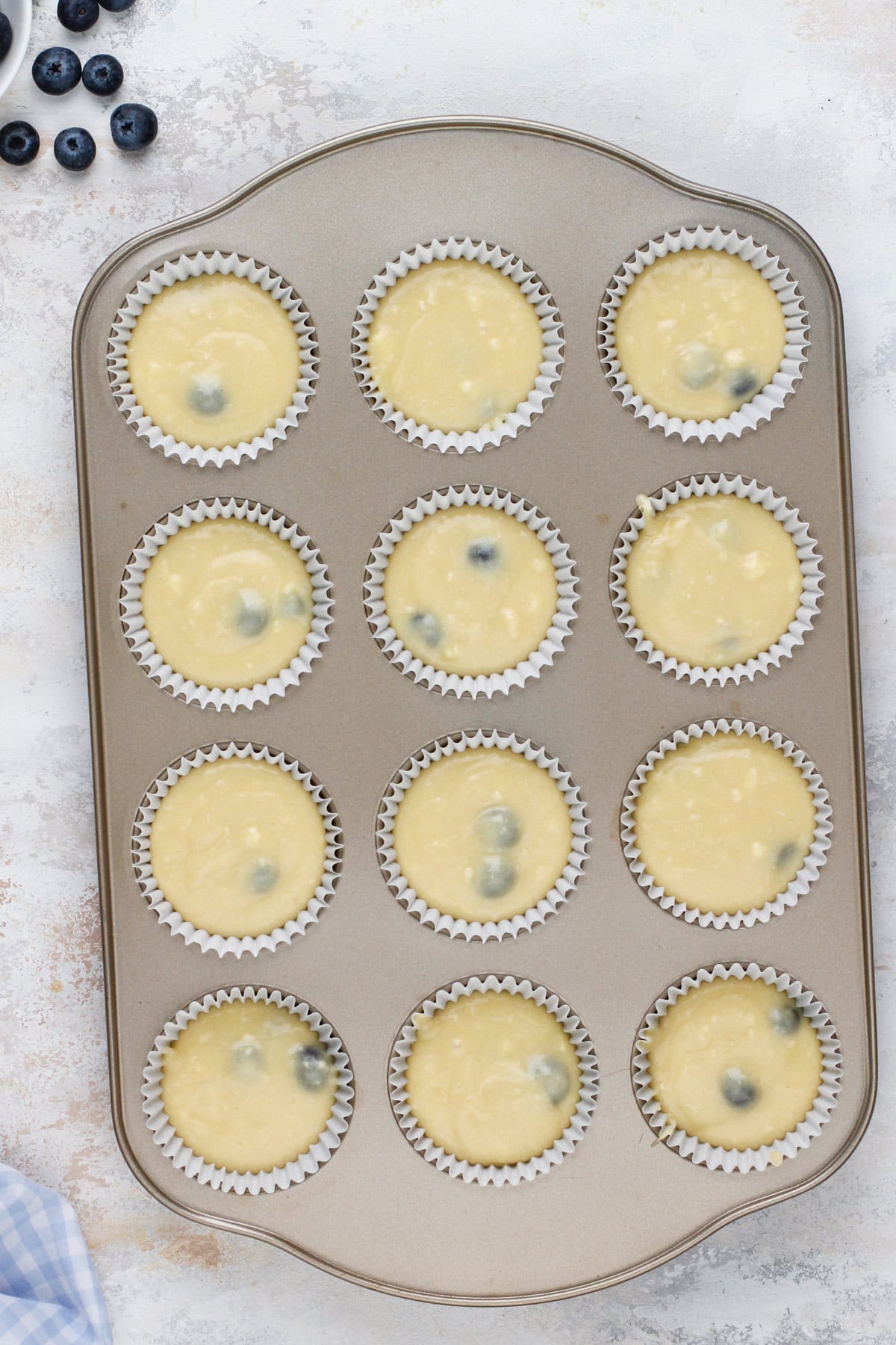 Unbaked blueberry cupcakes ready to go in the oven.