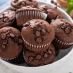 Double chocolate muffins in a white bowl.