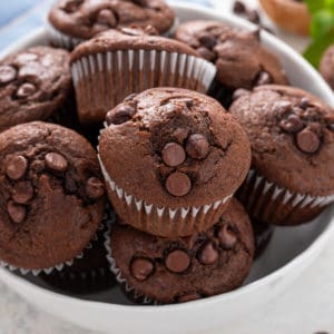 Double chocolate muffins in a white bowl.