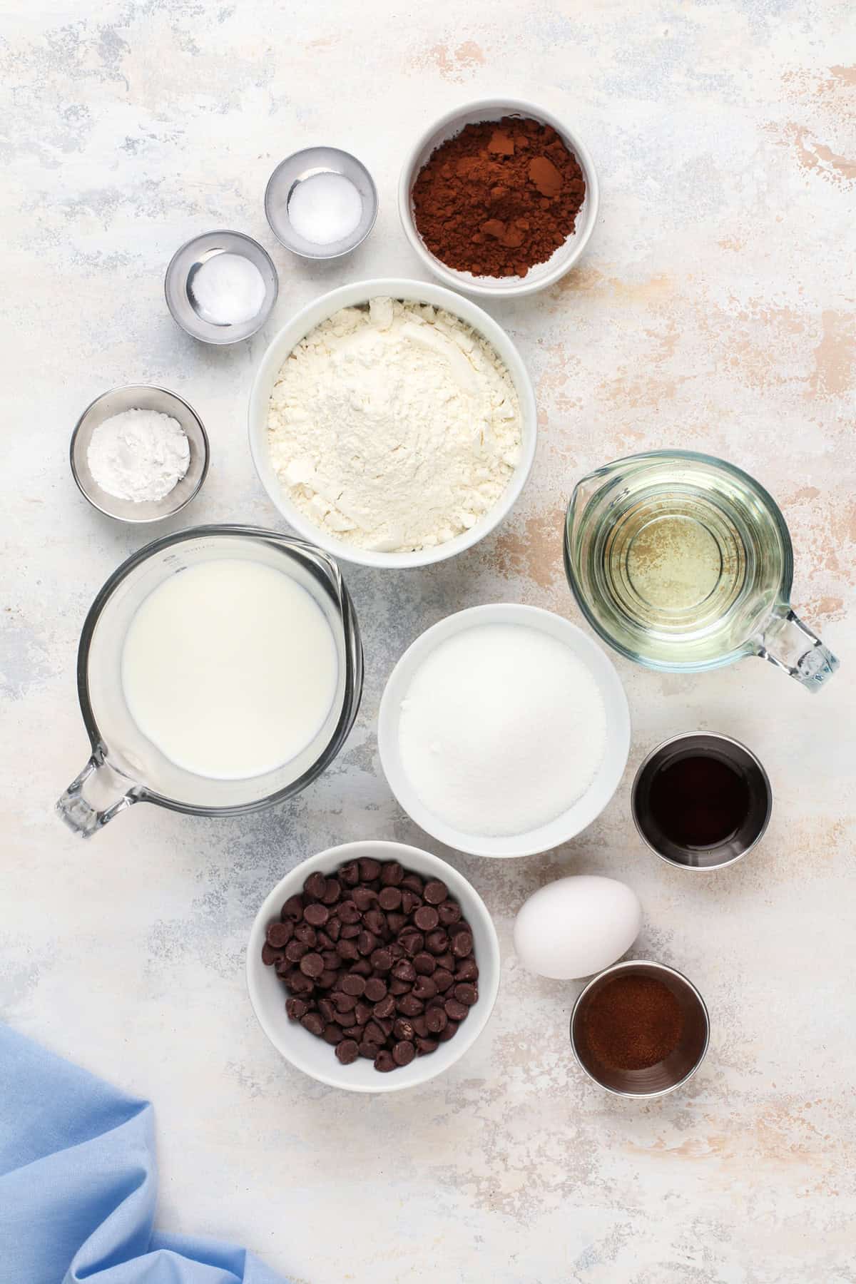 Ingredients for double chocolate muffins arranged on a countertop.