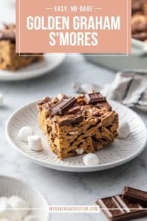 Golden graham s'more on a white plate with more plates in the background. Text overlay includes recipe name.