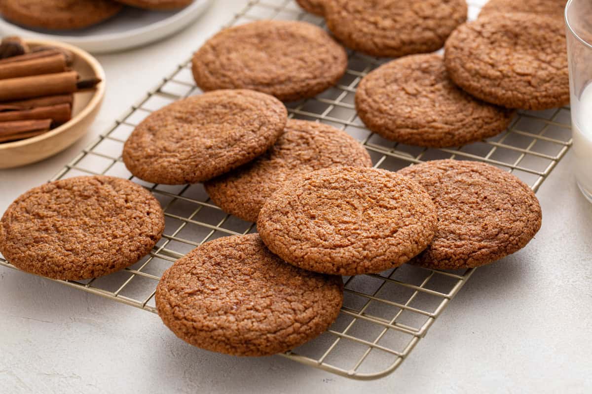 Molasses cookies scattered on a wire cooling rack.