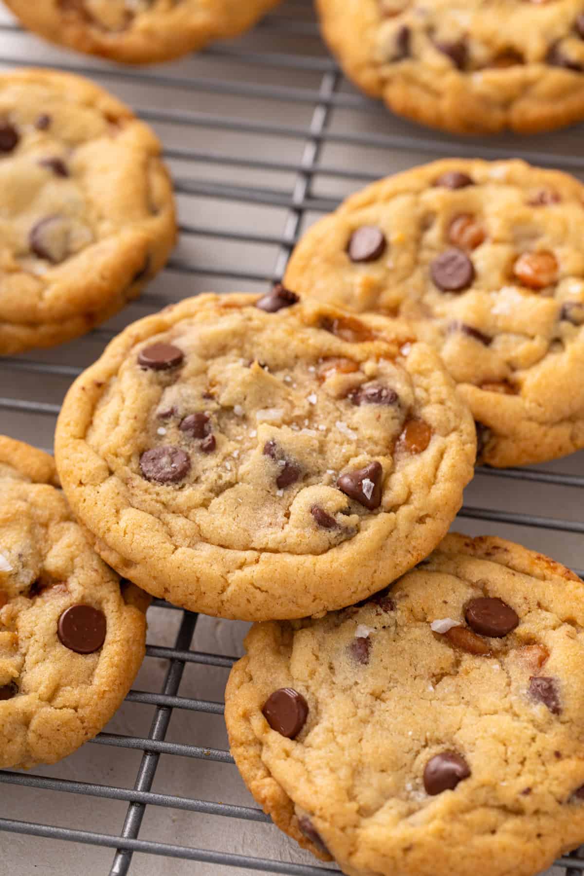 Close up of salted caramel chocolate chip cookies on a wire rack.