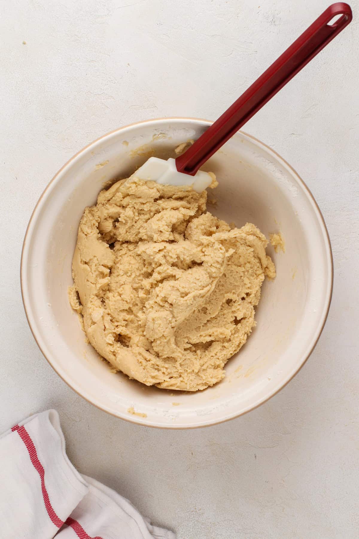 Dough base for salted caramel chocolate chip cookies in a mixing bowl.