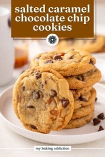 Salted caramel chocolate chip cookie leaning against a stack of the cookies on a white plate. Text overlay includes recipe name.