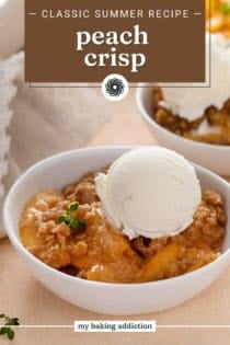 Close up of peach crisp topped with a scoop of vanilla ice cream in a white bowl. Text overlay includes recipe name.