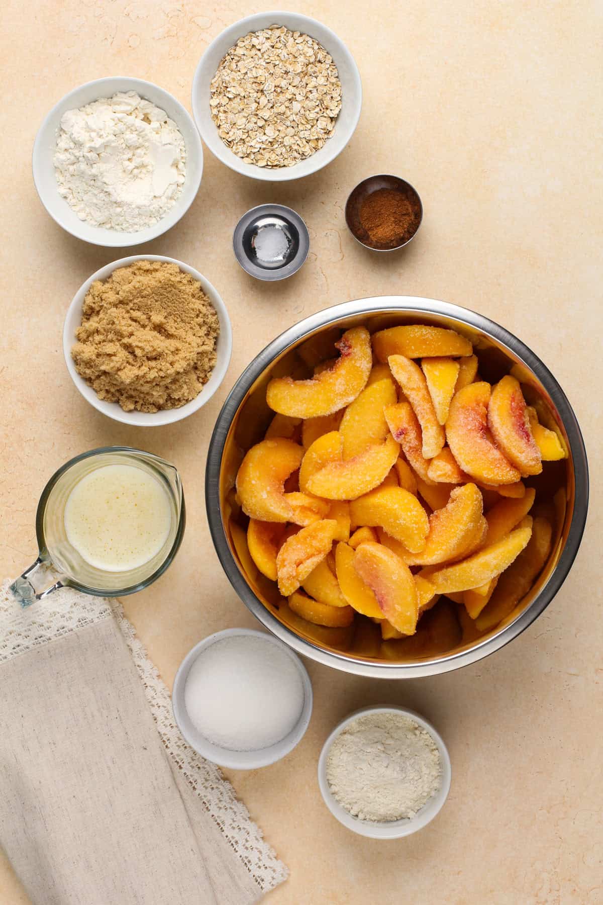 Peach crisp ingredients arranged on a countertop.