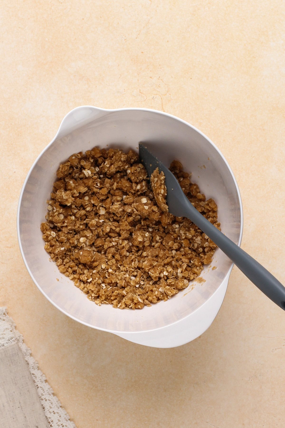 Peach crisp topping mixed in a white bowl.