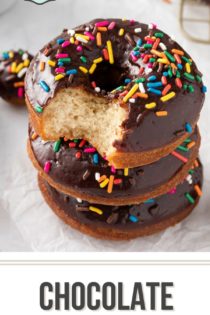 Three chocolate glazed donuts stacked on a piece of parchment paper. The top donut has a bite taken out of it. Text overlay includes recipe name.