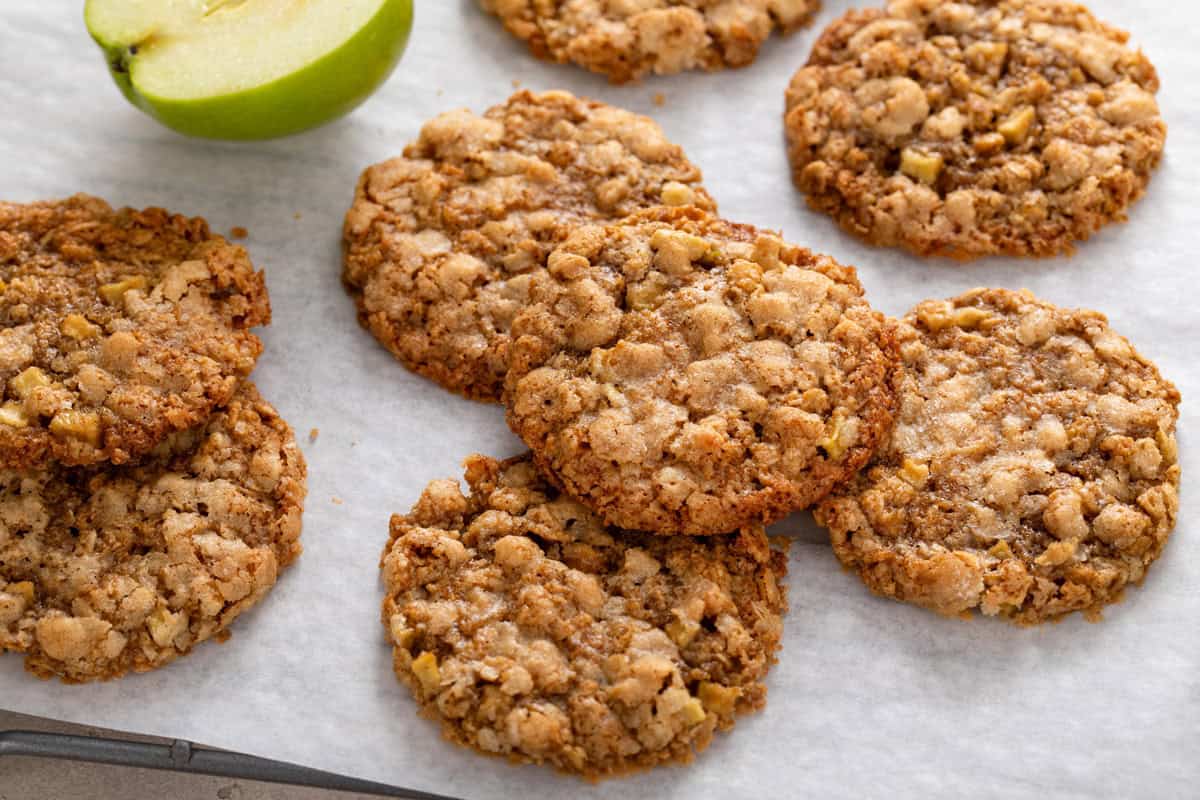 Apple spice cookies arranged on a piece of parchment paper.