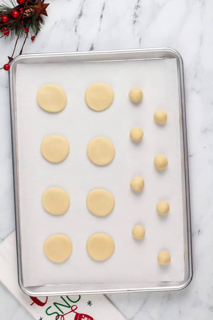Shaped sugar cookie dough on a baking sheet, ready to go in the oven.