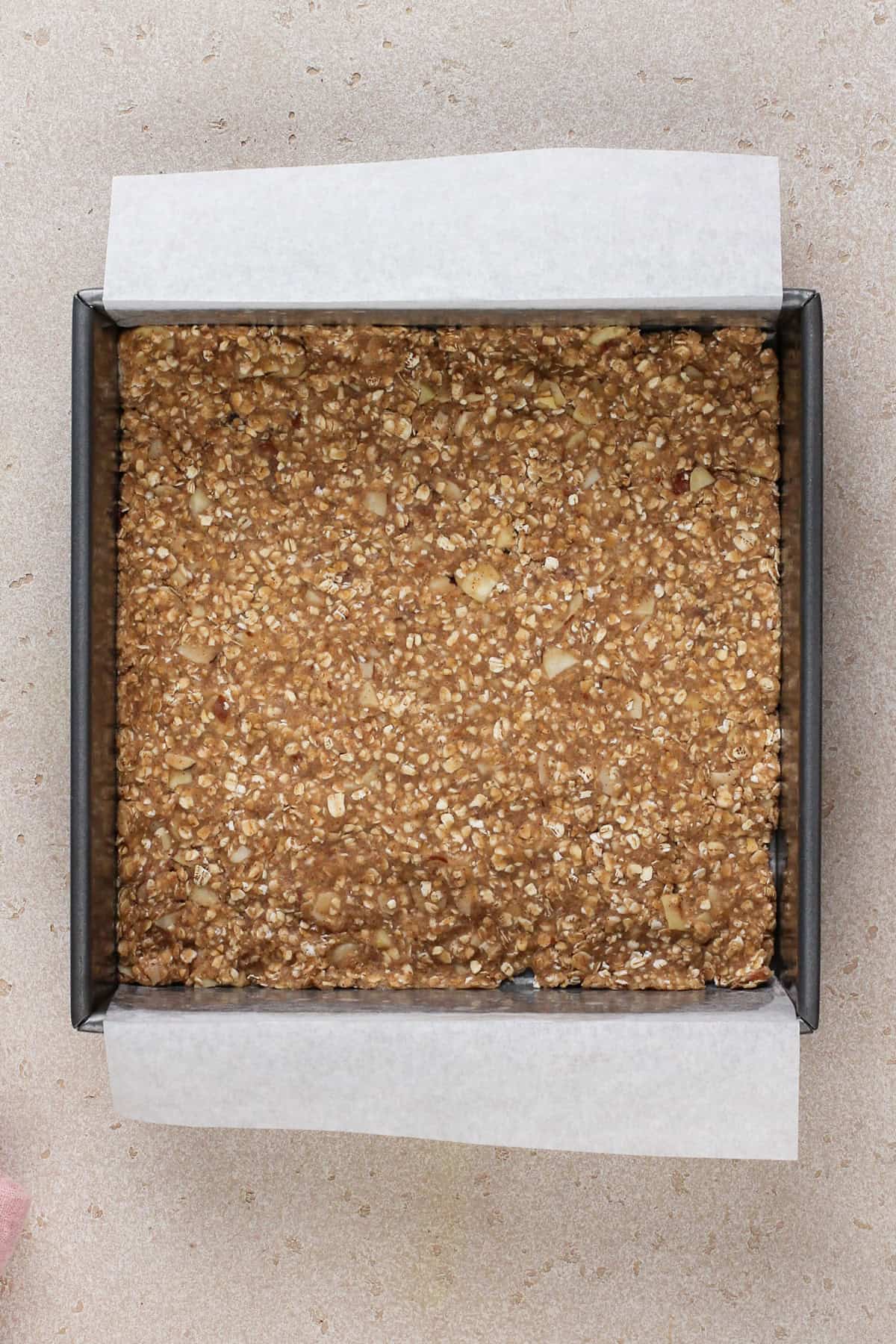 Crust for cherry cheesecake bars in a baking pan.