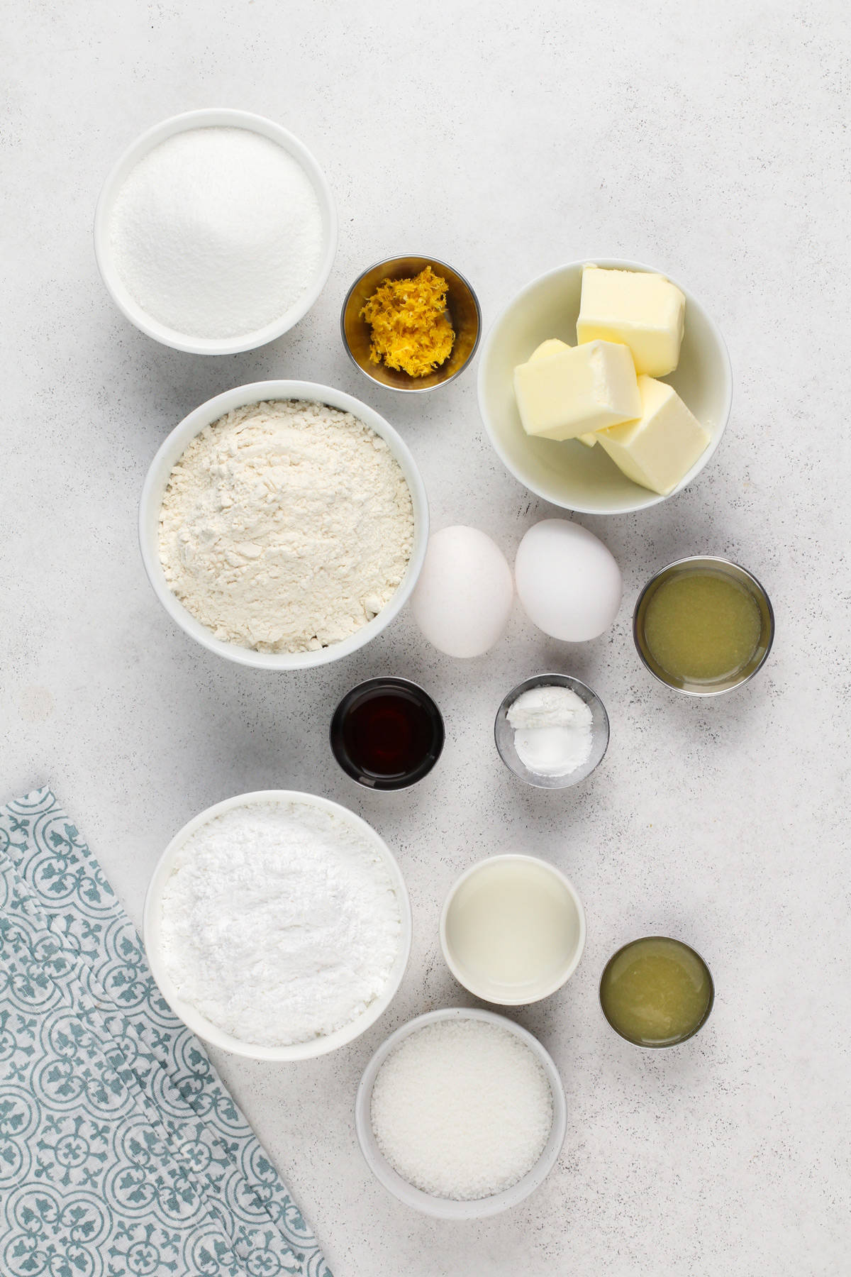 Ingredients for pound cake cookies arranged on a light countertop.