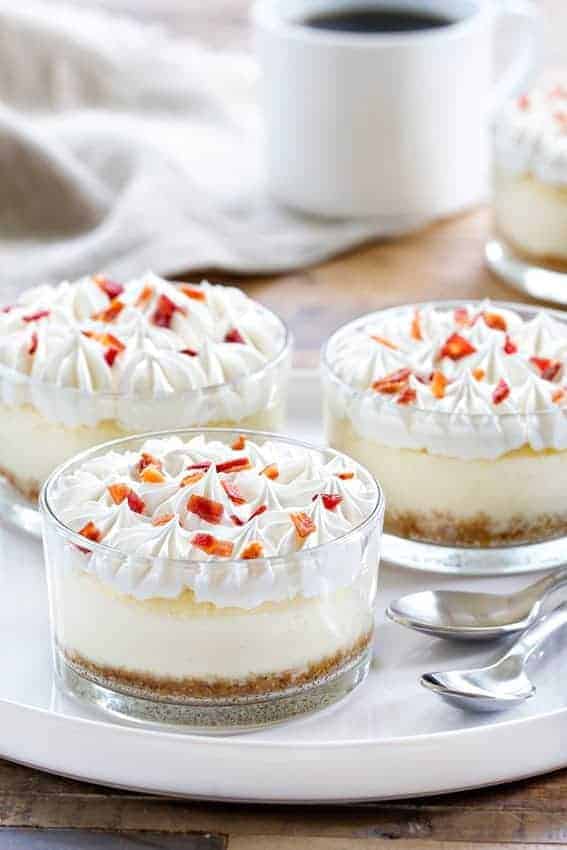 Maple Bacon Cheesecakes are the perfect sweet and salty combination. A dollop of whipped cream and candied bacon make them irresistible!