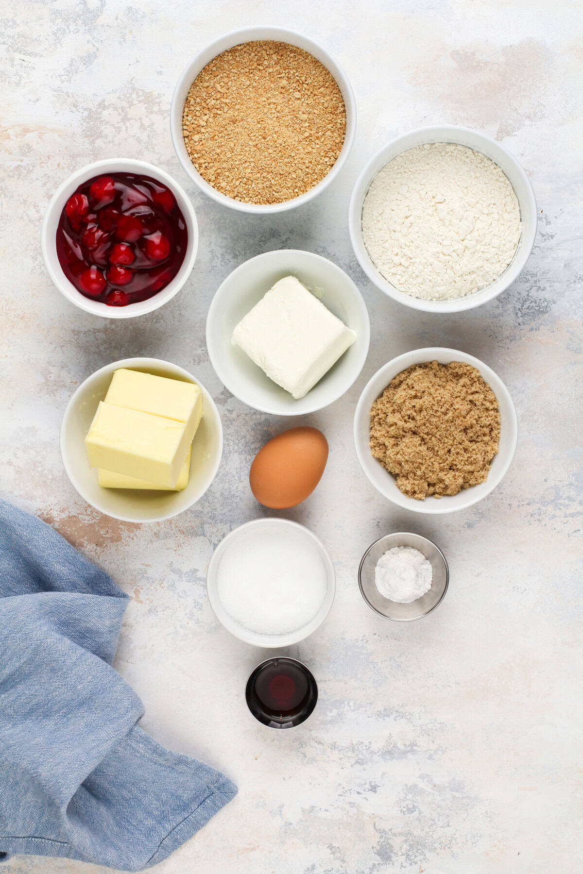Ingredients for cherry cheesecake cookies arranged on a countertop.