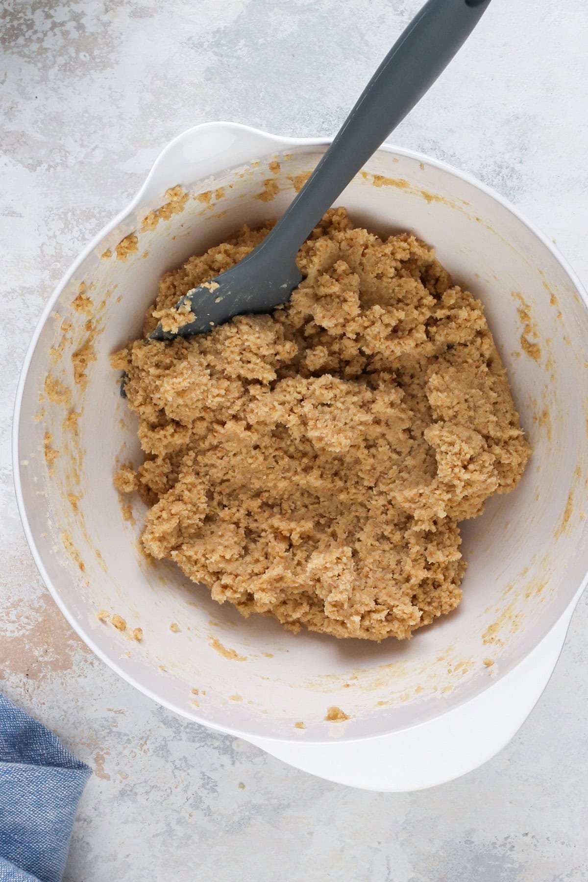 Cookie dough for cherry cheesecake cookies in a white bowl.