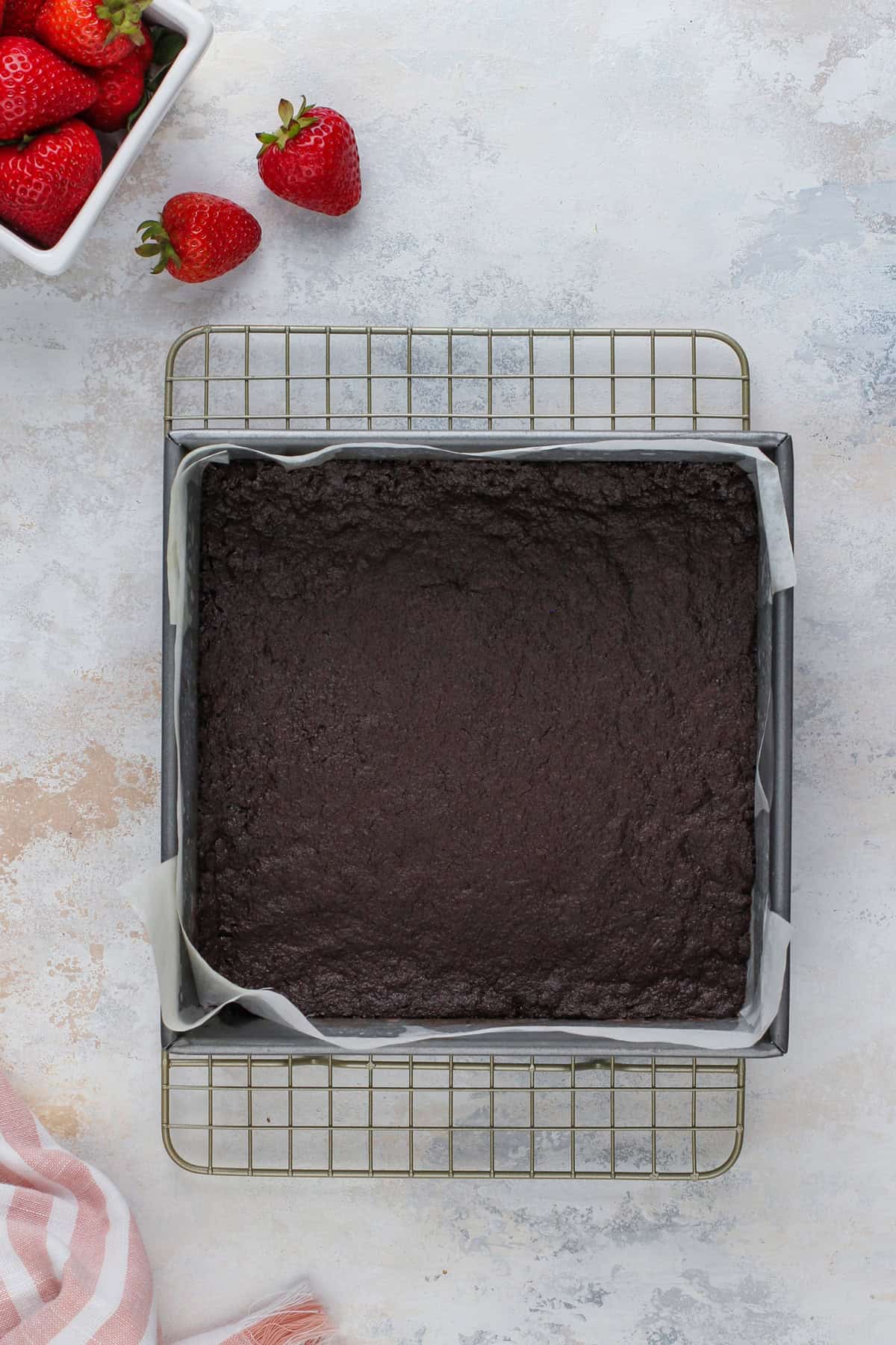 Baked and cooling chocolate crust for cheesecake bars.
