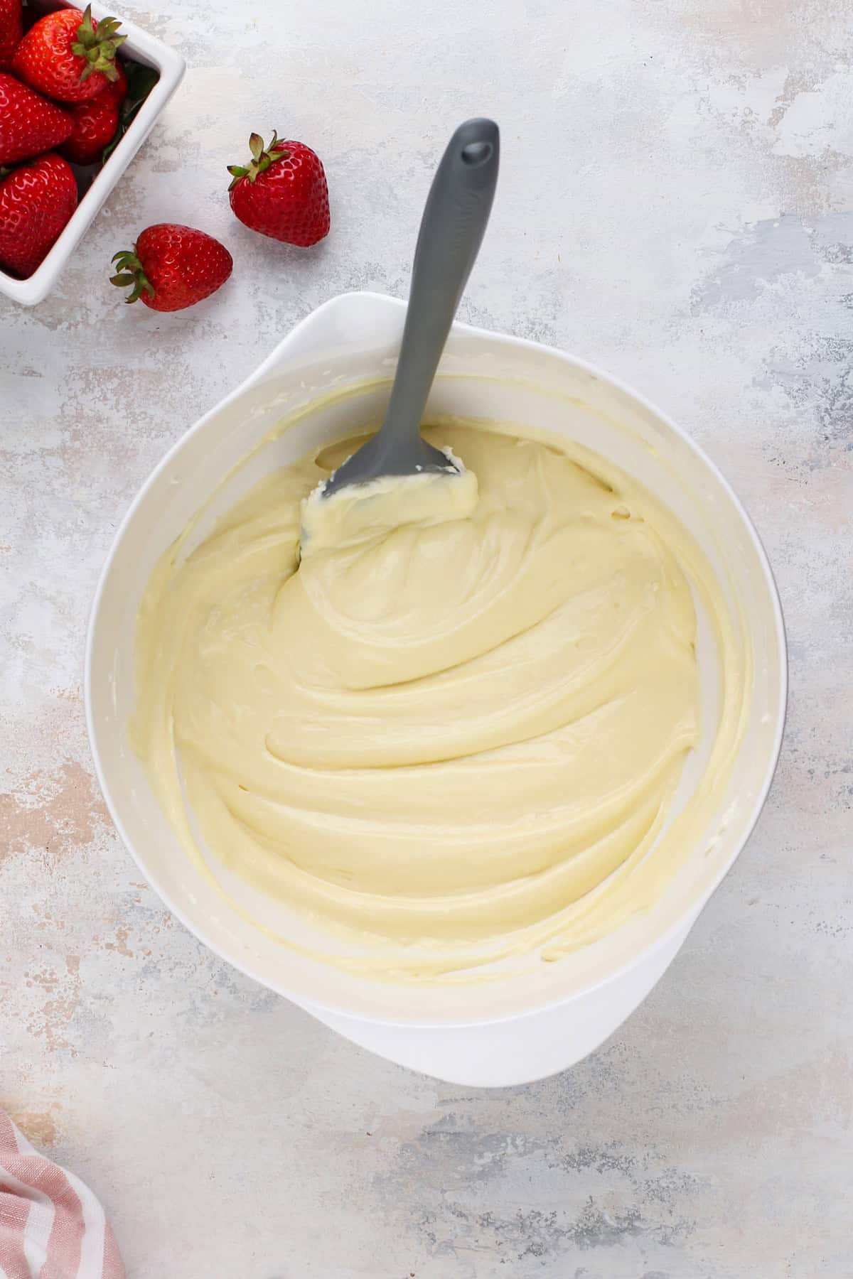 Cheesecake batter in a white bowl.