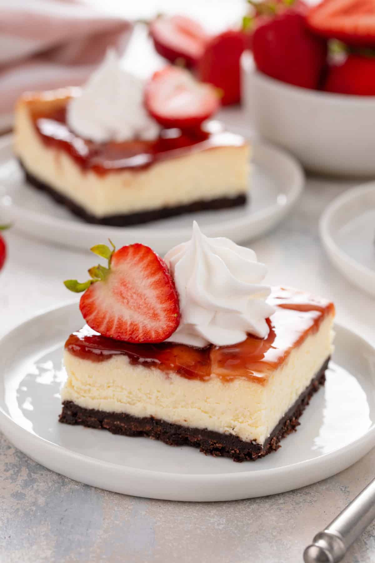 Strawberry cheesecake bar on a white plate.