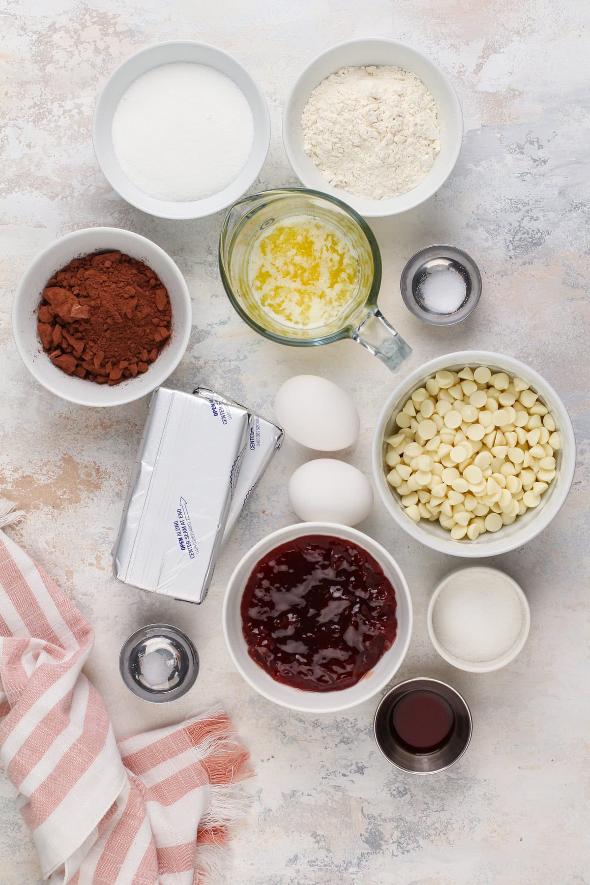 Strawberry cheesecake bar ingredients arranged on a countertop.