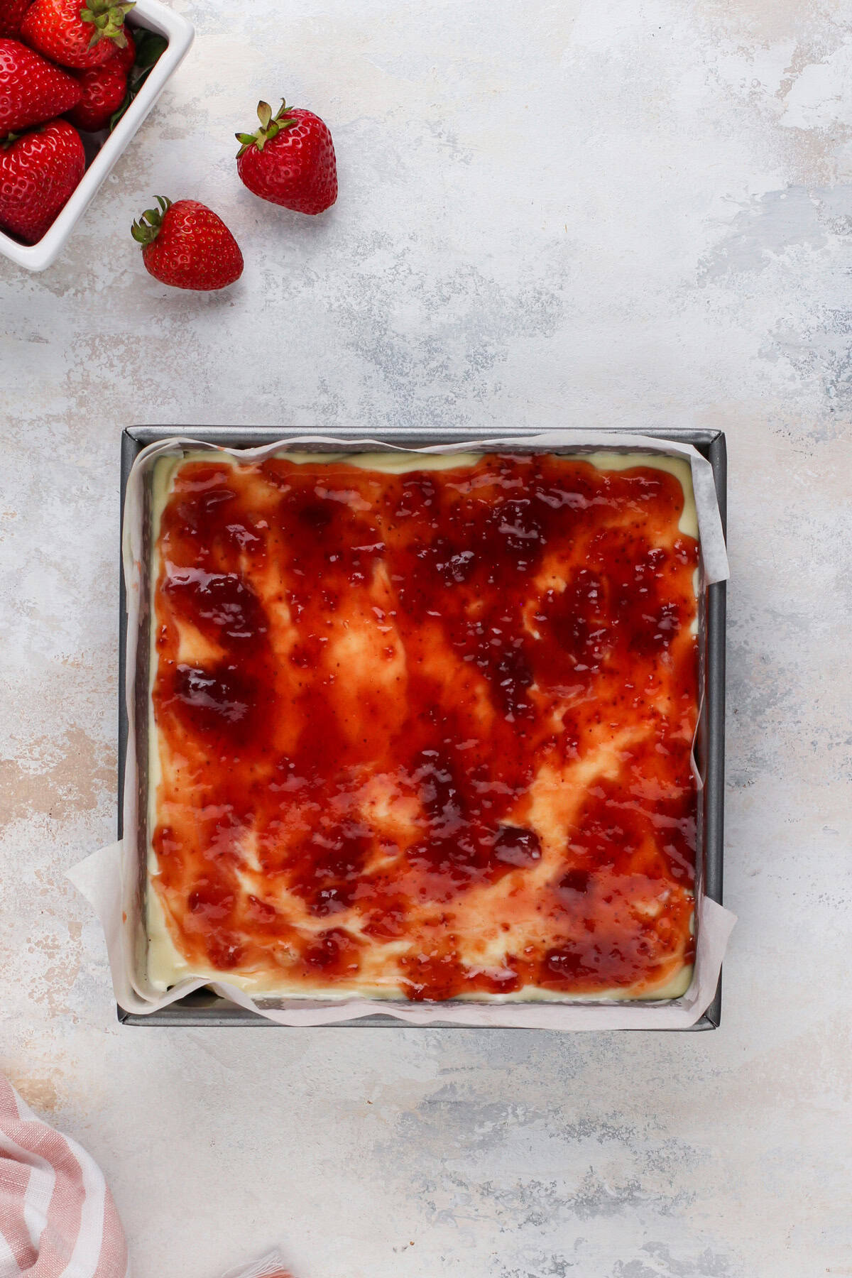 Unbaked strawberry cheesecake bars ready to go in the oven.