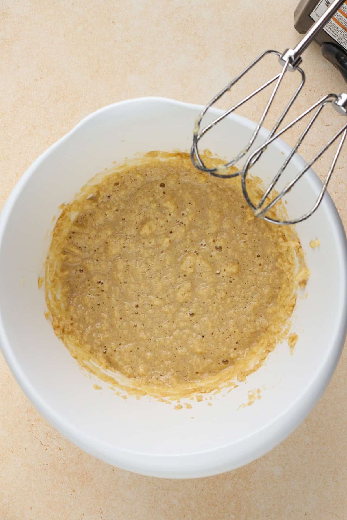 Wet ingredients for cookie crust mixed in a white bowl.