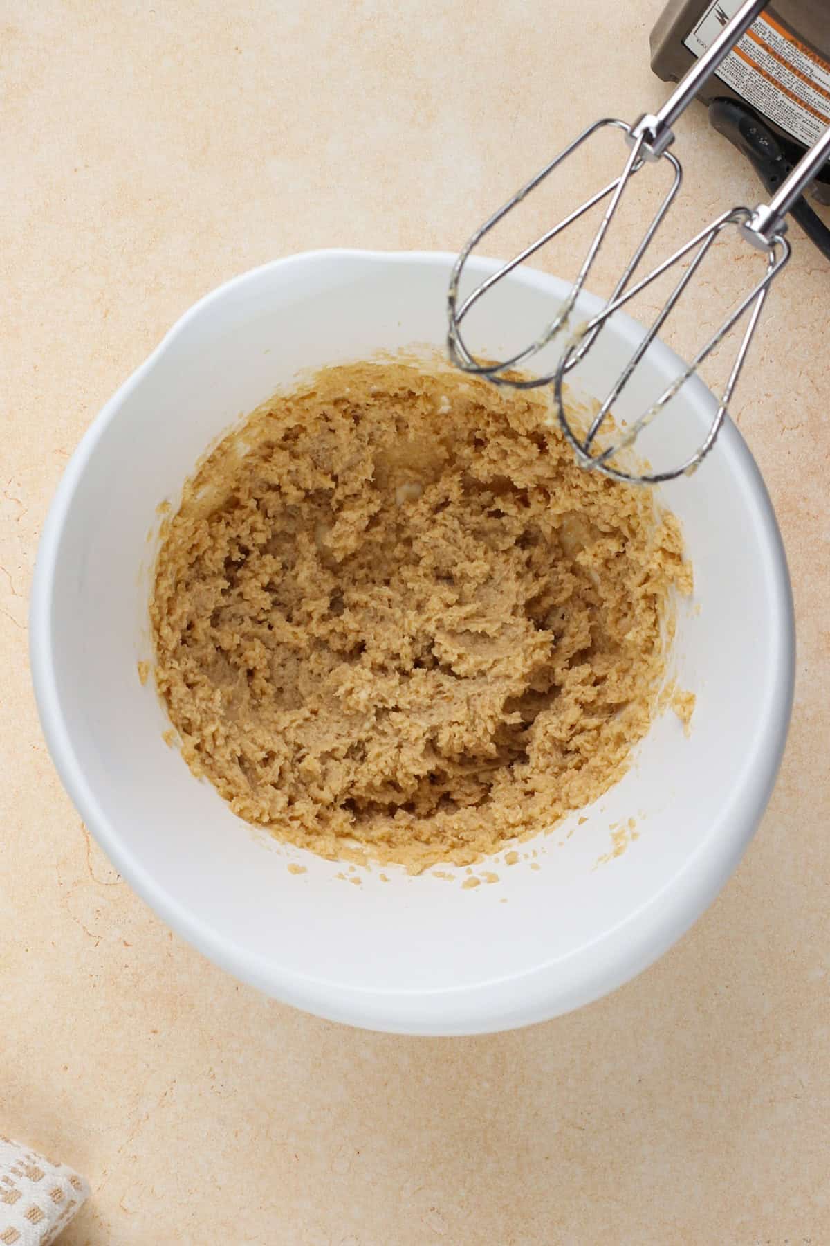 Butter and sugar for cookie crust dough mixed in a white bowl.