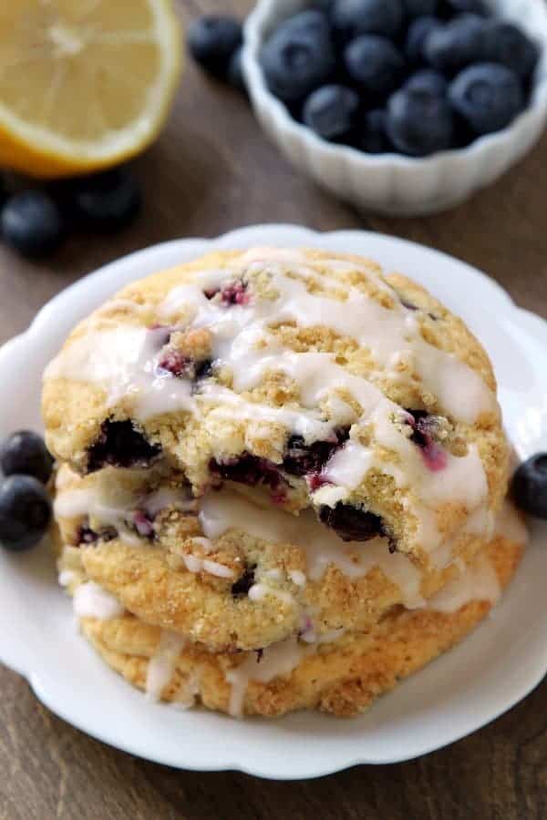 Blueberry Muffin Top Cookies are topped with streusel and a sweet and tart lemon glaze. They're great for breakfast, dessert, or a midday snack. Recipe contains a gluten-free option.