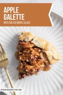 Overhead view of slice of apple galette topped with maple glaze on a white plate. Text overlay includes recipe name.