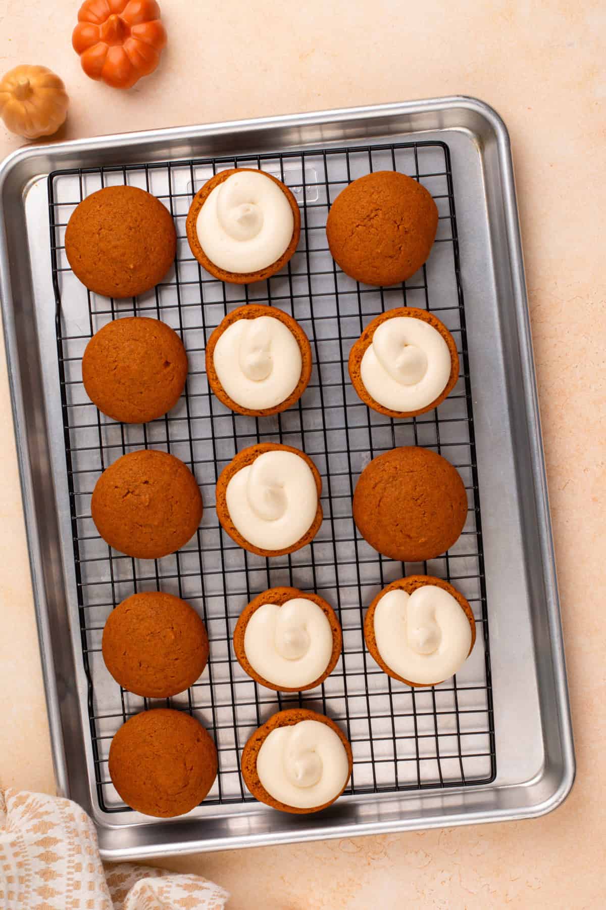 Cream cheese filling piped onto pumpkin cookies for whoopie pies.